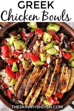 a bowl filled with chicken, cucumber and tomato salad on top of a wooden table