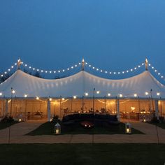 a large tent with lights on it at night