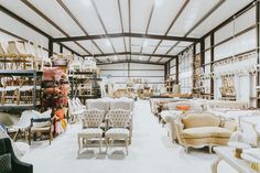 a large room filled with lots of furniture and chairs in it's center aisle