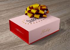 a pink and red box with a yellow bow