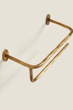 a pair of brass - plated glasses hang on a wall