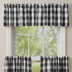 black and white checkered curtains hanging in front of a window