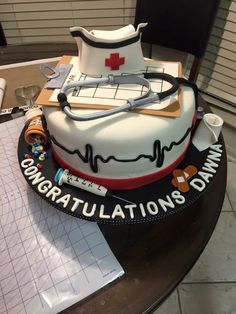 a cake that is on top of a table with medical equipment in the shape of a boat