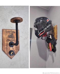 a helmet mounted to the side of a wall next to a skateboard on a wooden board