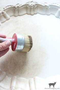 a person holding a paint brush in their hand