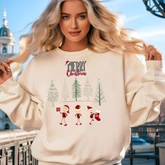 Merry Christmas Elf Sweatshirt | Cute Holiday Elf and Tree Design | Fun Festive Christmas Sweater | Cozy Holiday Gift Idea for Winter Get into the holiday spirit with this adorable Merry Christmas Elf Sweatshirt! Featuring three cheerful elves surrounded by festive Christmas trees, this cozy sweatshirt is perfect for adding some fun and joy to your holiday celebrations. Whether you're looking for a unique Christmas sweater for yourself or a thoughtful holiday gift, this design will bring a smile to anyone's face. The cute elves, 'Merry Christmas' text, and festive trees create a fun and cheerful vibe that's perfect for winter gatherings, parties, or lounging at home. Available in multiple sizes, this sweatshirt is ideal for spreading holiday cheer! The unisex soft cotton sweatshirt is a se Elf Sweatshirt, Merry Christmas Text, Christmas Text, Cozy Holiday, Sweatshirt Cute, Tree Design, Cozy Sweatshirts, Tree Designs, Christmas Elf