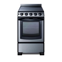 a silver stove top oven sitting next to a white wall