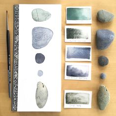 some rocks and watercolor pencils on a table