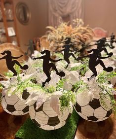 soccer themed centerpieces are displayed on a table