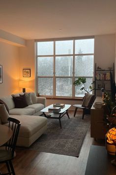 a living room filled with furniture and a large window covered in frosty glass windows