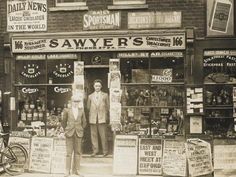 two men standing in the doorway of a store