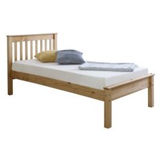 a wooden bed frame with two pillows on top and one pillow on the bottom side