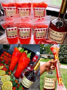 some bottles and glasses filled with liquid next to strawberries, lemons, and limes