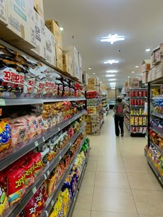 an aisle in a grocery store filled with lots of food and snacks on the shelves