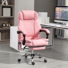 a pink office chair sitting in front of a computer desk with a monitor on it