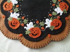 a halloween themed place mat with ghost and pumpkins on it