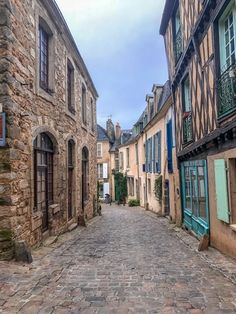 an old cobblestone street with stone buildings