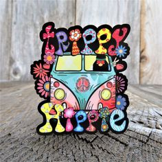 a sticker with the words happy hippie written in colorful letters and flowers on it