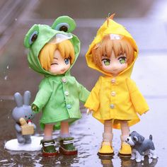 two dolls are standing in the rain holding hands