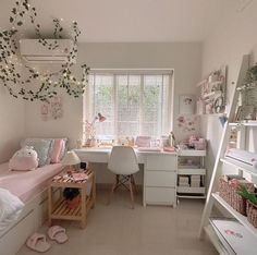 a bedroom with white furniture and lots of pink decorations on the walls, along with shelves