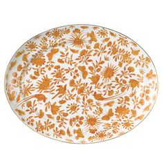 an orange and white plate with floral designs on the rim, against a white background