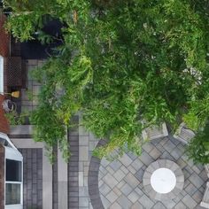 an aerial view of a patio and table surrounded by trees