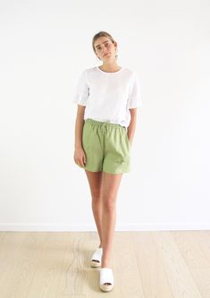 This season's Evie shorts have been handmade in a mid-weight earthy green linen. High waisted with an elastic waistband, drawstring tie, internal side seam pockets  these are a classic summer staple.  Features: - 100% Linen- approx 165gsm - Elastic waistband with drawstring - Internal side seam pockets - Handmade in Byron Bay, Australia   Model is 5'8, measures at bust 85cm, waist 65cm and hip 92cm and is wearing an XS.  Available Sizes (your measurements):  XS/ AU 8 Bust: 85cm (33 1/2 in) Waist Green Linen Shorts Outfit, Linen Shorts Outfit, Mini Wrap Skirt, Summer Beach Shorts, Earthy Green, Byron Bay Australia, Beautiful Skirts, Summer Staples, Byron Bay