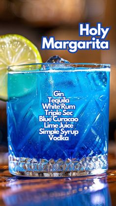 a blue cocktail with lime and vodka on the side