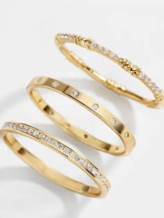 For fans of bands, there's the Maddie 18K Gold Ring Set. Featuring three unique stacking rings, this set can be broken apart on multiple digits or worn all on one. All three of the bands feature petite Cubic Zirconia stones. Crafted with 18K gold plated sterling silver, this is sure to be one of your new favorite pieces of jewelry. Gold Medallion Necklace, Ups Shipping, 18k Gold Earrings, Opal Ring Gold, Jewels Rings, Gold Ring Sets, 18k Gold Ring, Modern Ring, Affordable Jewelry