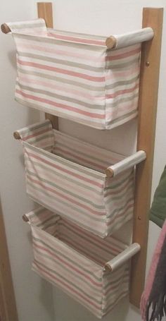 a shelf with several folded towels on it and a towel rack in the corner next to it