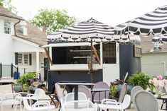 an outdoor dining area with umbrellas and chairs