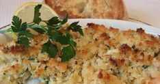 a close up of a plate of food with bread and garnish on it