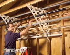 a man is working on some kind of rack in a building with wood paneling