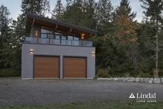 a two car garage sits in front of some trees