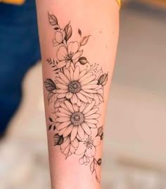 a woman's arm with flowers on it