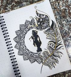 a spiral notebook with an image of a woman holding a feather