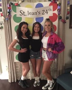 three girls standing in front of a sign that says st jean's 24 th