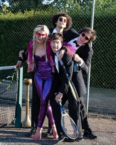 a group of people in costume posing for a photo with tennis racquets