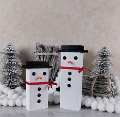 two snowmen are standing next to each other