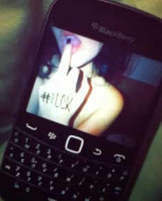 a person holding up a cell phone with the word flickr on it's screen