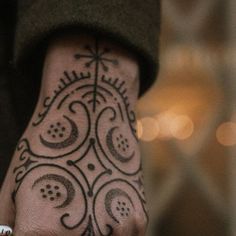 a person's hand with a tattoo on it