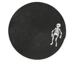 a round woven placemat with a skeleton on the front and white outline in the middle