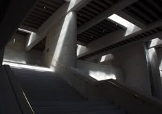 stairs leading up to the top of a building with sunlight coming in from above them