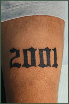 a man with a tattoo on his leg that says 2010 in cursive font