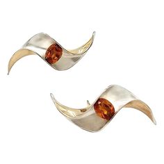 Modernist Silver & Gold Earrings set with 8x6 mm Citrine. In 1996 Gerhard Herbst studios began exploring ways to incorporate gemstones into Herbst’s Anticlastic forms. The outcome of these investigations resulted in the columniation of ten works that utilized tension setting as a solution to fit semiprecious stones into his pieces. Pinwheel earrings was produced from 1996 to 2000 and although several works were manufactured in sterling this piece is one of only four produced in sterling silver and 14k Gold.   Condition: Excellent / archive vintage  Estimated total production: 28 pieces Marks: Sterling/ Signed by Artist  Modernist designer, Gerhard Herbst translates sculptural form into the jewelry medium. Popularly known for his spatial shapes and fluid manipulations of metal, Herbst began Gold Earrings Set, Silver Gold Earrings, Vintage Stud Earrings, Tension Setting, Modernist Jewelry, Garnet Earrings, Citrine Stone, Jewelry Studio, Yellow Gold Earring