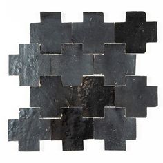 a black and white tile design with squares on it's sides, in the shape of an interlocked rectangle