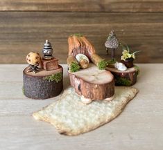 miniature figurines sitting on top of wooden stumps