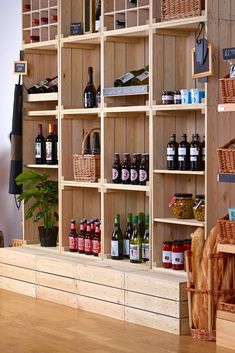 a wooden shelf filled with lots of bottles