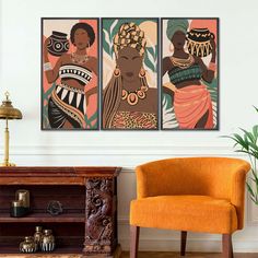 three african women in traditional dress hanging on a wall next to a chair and table