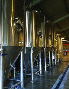 several large metal tanks lined up in a room